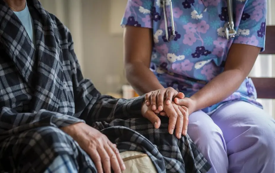 nurse comforting a nursing home patient
